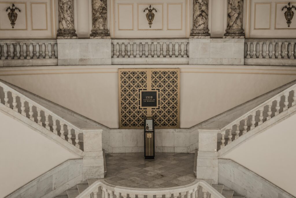 Grand staircase of the Grand Theater of Havana with an exhibition of Havana Club 1519 rum on a pedestal