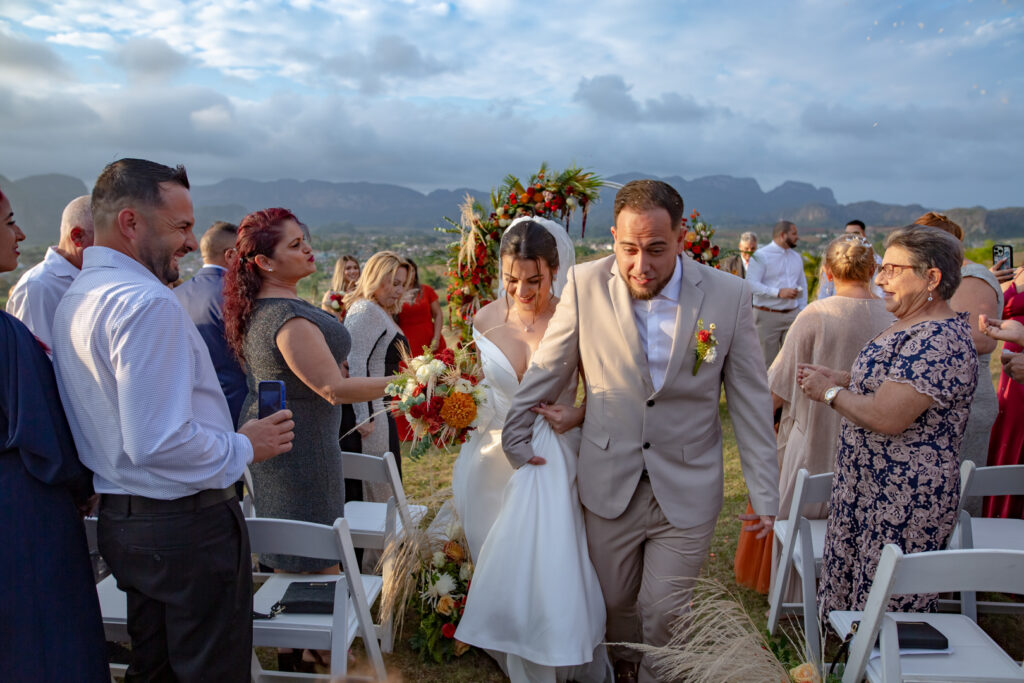 Novios caminando entre aplausos tras la ceremonia de boda en Viñales