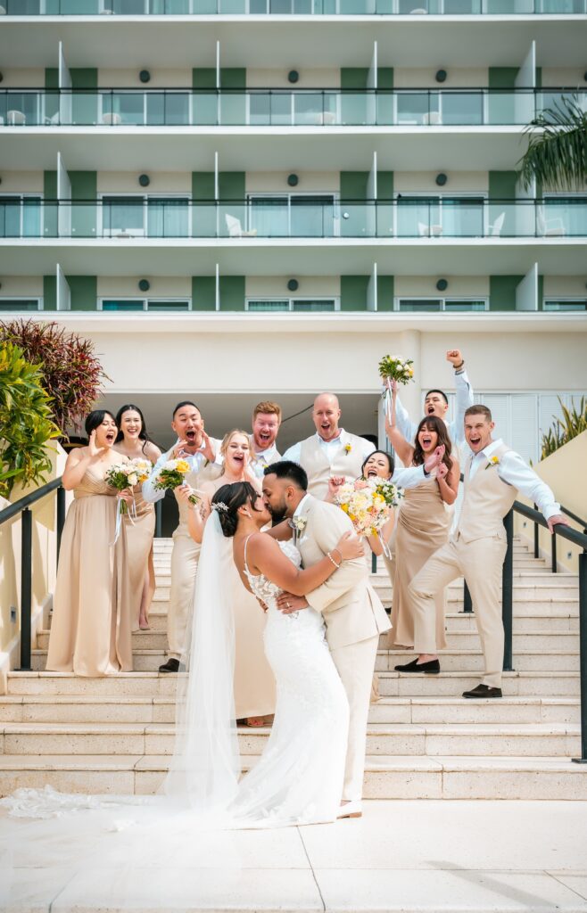 The couple with their full wedding party on the steps of the Meliá Internacional Varadero hotel.