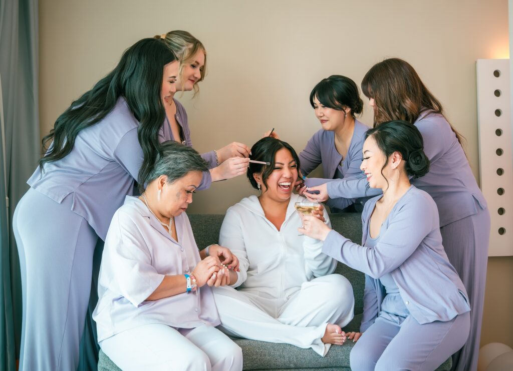 Her bridesmaids help the bride get ready, with laughter and complicity