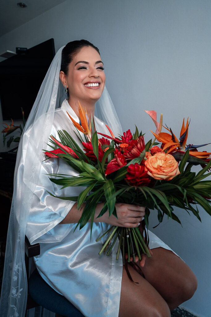 Bride getting ready with a warm-colored tropical bouquet before the wedding at the Hotel Nacional