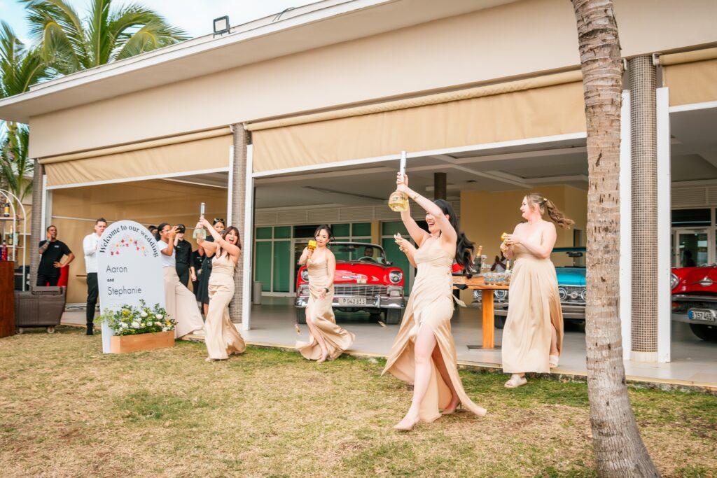 Bridesmaids throw play money on the dance floor at their wedding in Varadero