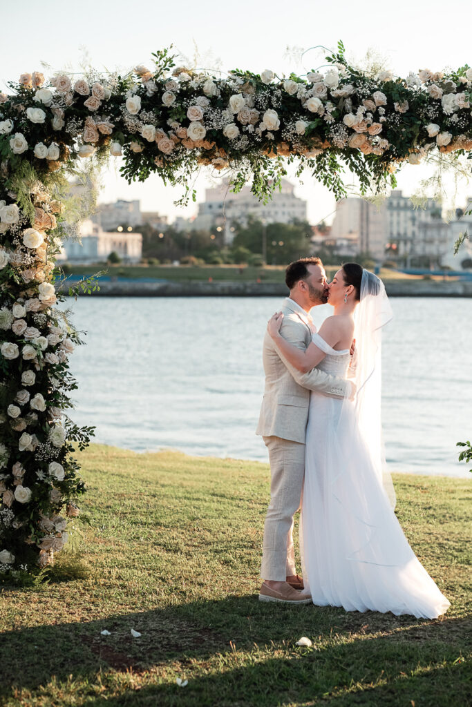 Los novios se besan al finalizar la ceremonia con la ciudad detrás