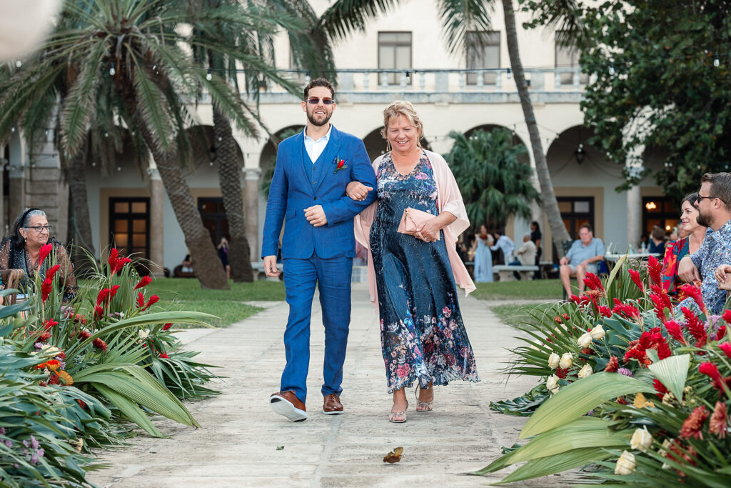 Groom walking down the aisle at the Hotel Nacional hand in hand with his mother