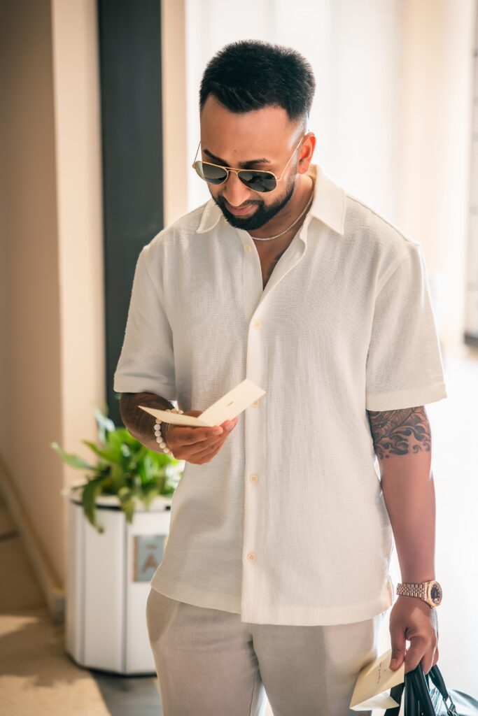 With emotion, the groom reads a note before getting dressed for the ceremony