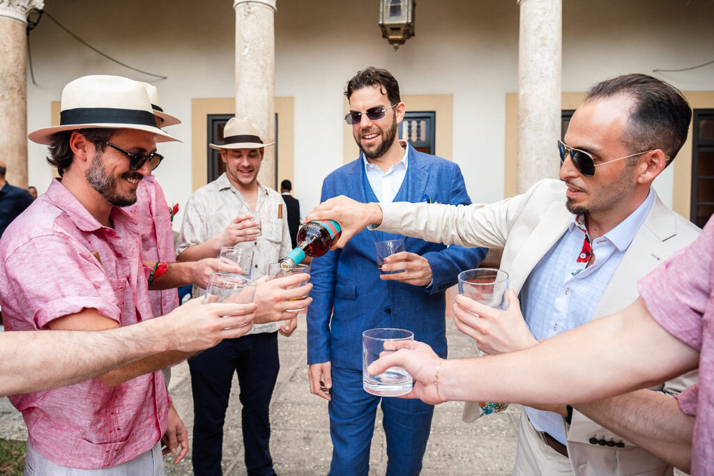 The groom and his wedding party prepare a toast before getting married at the Hotel Nacional