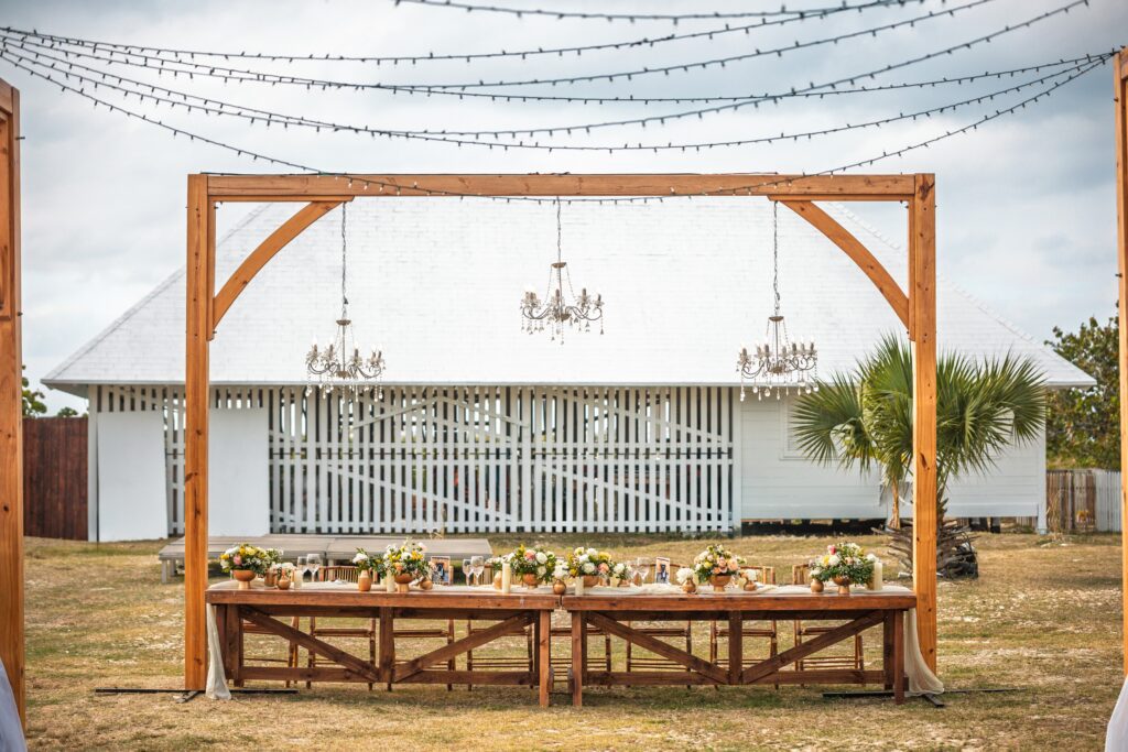 View of the head table in the garden with hanging chandeliers