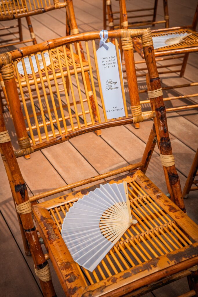 Detail of a fan and reserved seat sign on a wooden chair