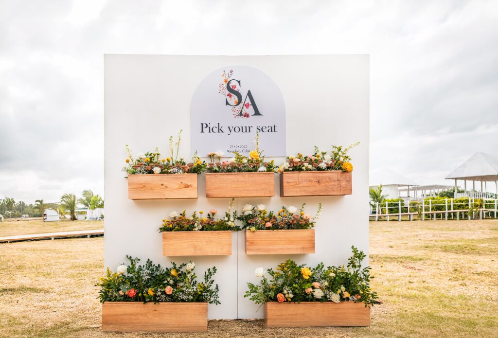 Seating chart sign with floral planters and engraved names