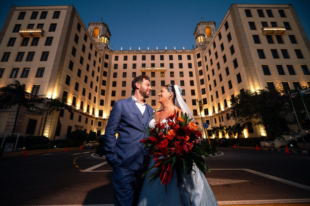 Bride and groom together at sunset with the Hotel Nacional building behind them