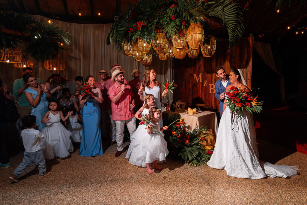 Celebrating with guests in the decorated Hotel Nacional hall with custom monogram and wooden details