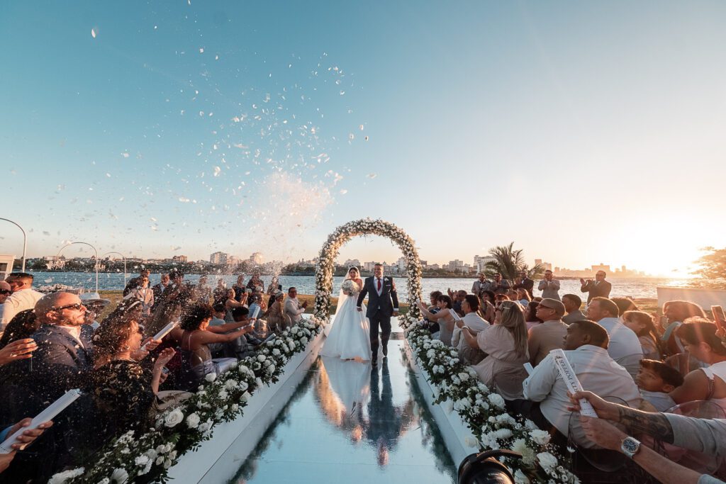 Exit of the newlyweds through a shower of petals after the wedding ceremony at La Divina Pastora.