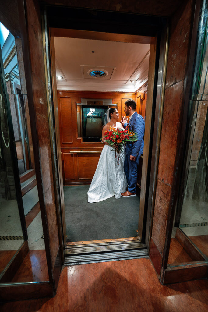 Bride and groom inside the mirrored wooden elevator at the Hotel Nacional during their wedding