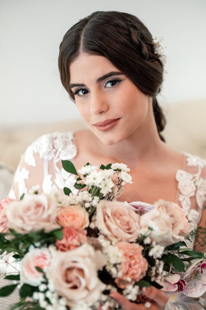 Close-up of bride with a rose bouquet and a calm gaze