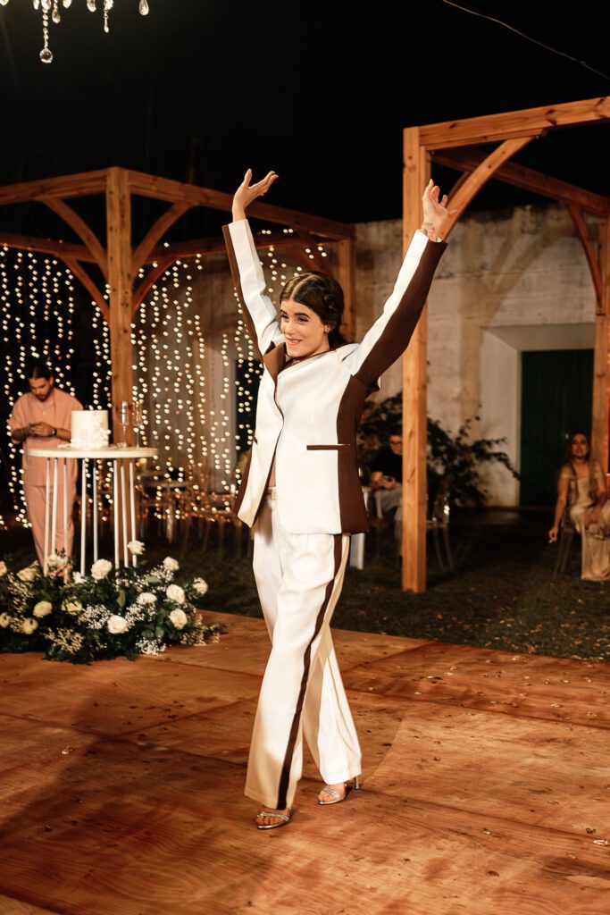 Bride dancing with arms raised during the reception of her wedding in Havana