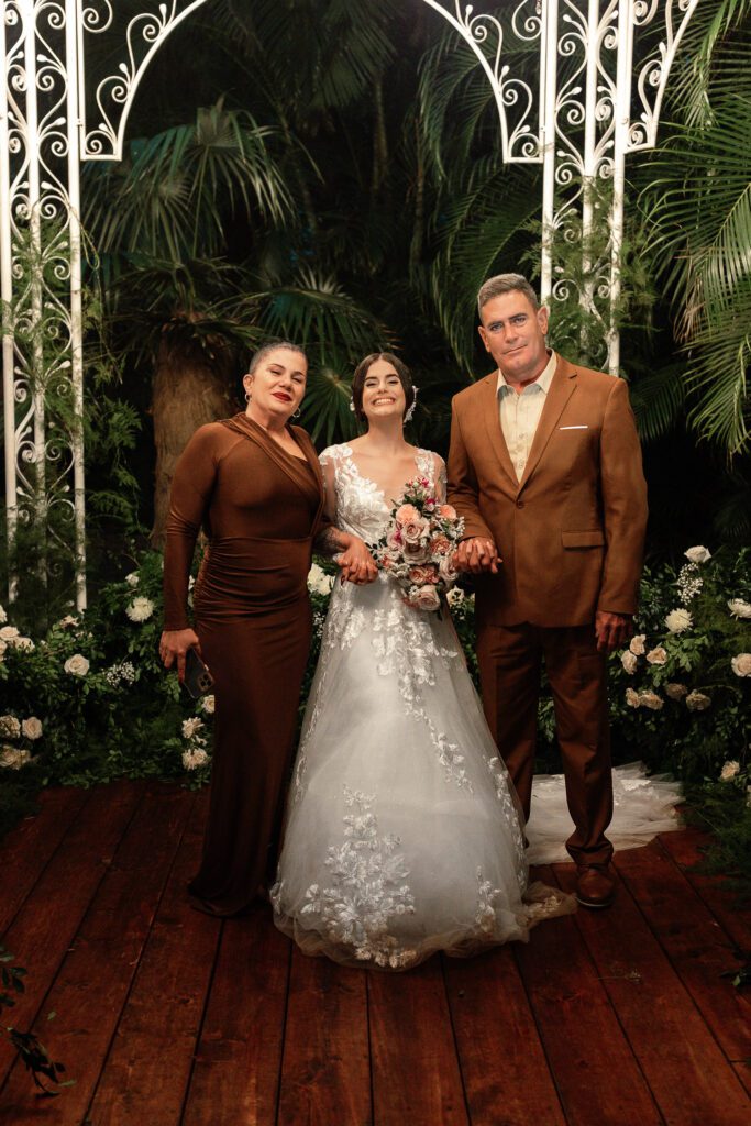 Gabriela smiles beside her mother and father during her ceremony in Havana