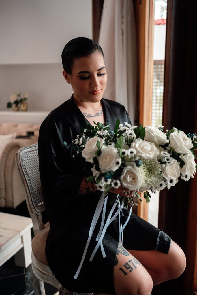Bride holding her white flower bouquet before the wedding in Cuba under the most beautiful dome