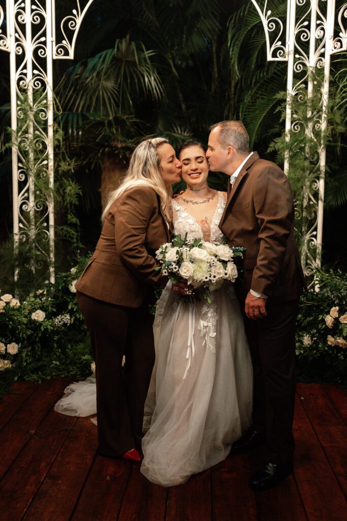 Parents kissing the bride during her wedding in Cuba under the most beautiful dome