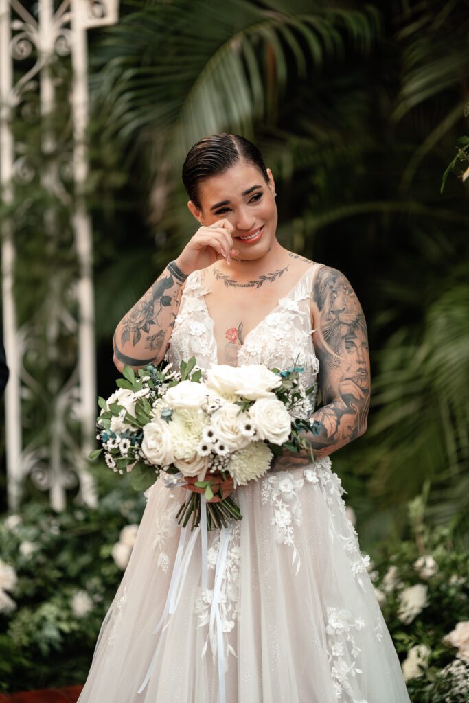 Sheyla gets emotional during the ceremony as she listens to a special audio, bouquet in hand
