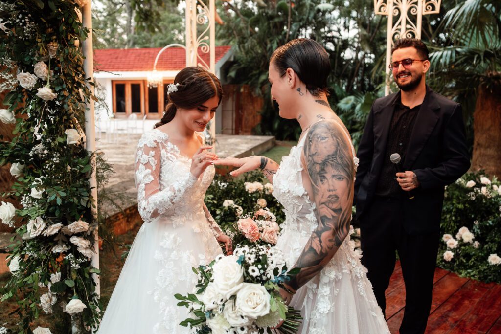One of the brides places the ring on her partner during the ceremony in Cuba