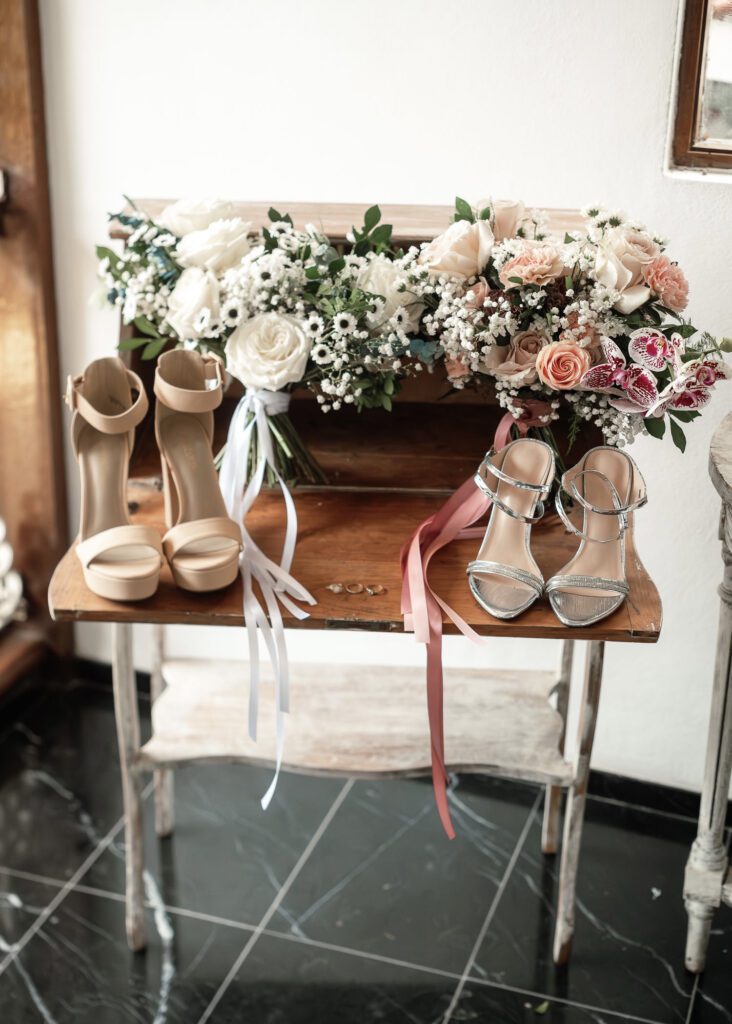 Bridal bouquet and wedding shoes on a table at a wedding in Cuba under the most beautiful dome